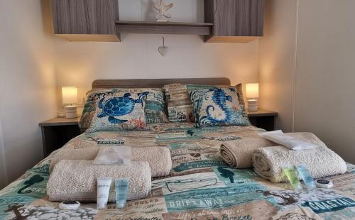 a bed with two pillows and towels on it at Island Escape Sandown in Sandown