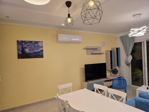 a living room with a white table and chairs at Peaceful Challette Two Bedrooms in Murano El Sokhna in Ain Sokhna