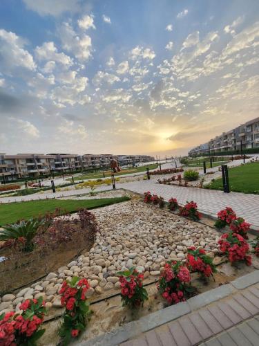 a walkway with flowers in a park with buildings at Peaceful Challette Two Bedrooms in Murano El Sokhna in Ain Sokhna