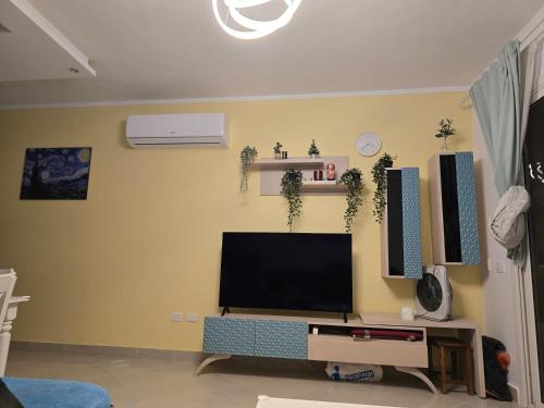 a living room with a flat screen tv on a wall at Peaceful Challette Two Bedrooms in Murano El Sokhna in Ain Sokhna