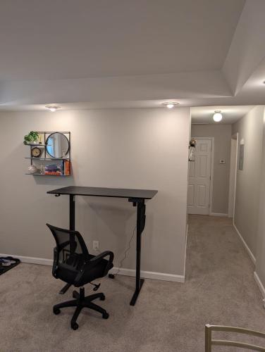 an office with a black desk and a chair at 2 Bedroom Basement Home in Conley