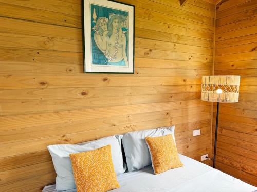 a bedroom with wooden walls and a bed with pillows at Tropical Villa, Private Lagoon in HUH