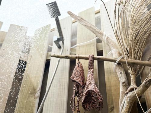 a shower in a building with two shoes hanging from it at Tropical Villa, Private Lagoon in HUH