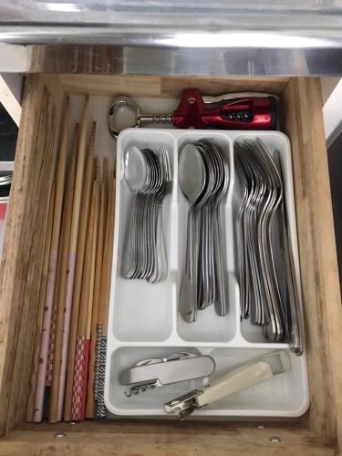 a drawer filled with utensils and other kitchen utensils at O2 capsule house OTARU in Otaru