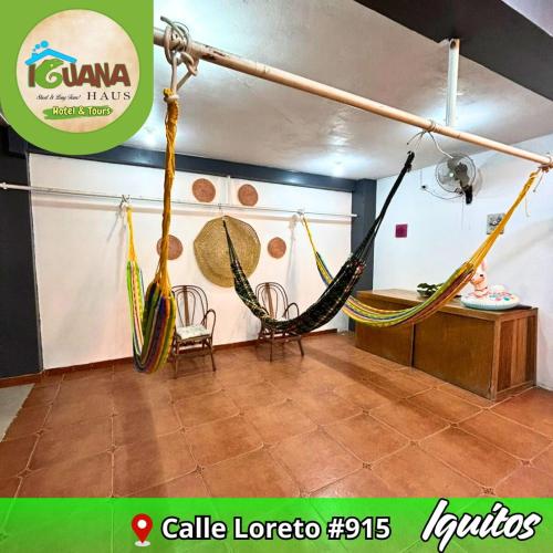 a room with two hammocks and a table at IGUANA HAUS IQUITOS in Iquitos
