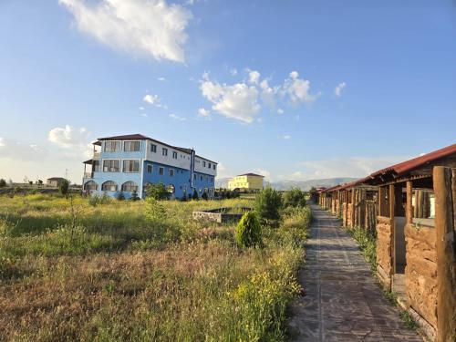 a blue building in the middle of a field at Parasut Village Hotel in Kargakonmaz