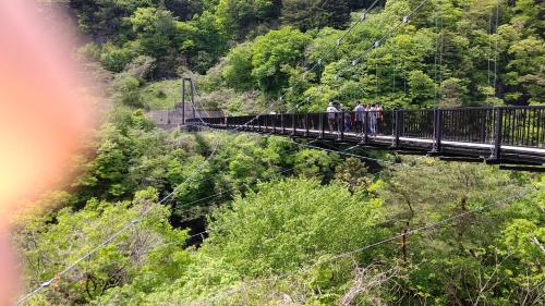 a group of people standing on a suspension bridge at Akira Peak House annex in Nikko