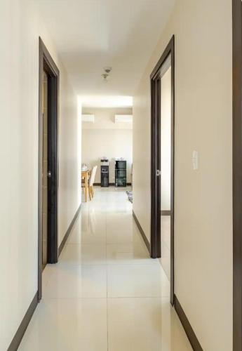 an empty hallway with two doors and a room at Mystay25V-ParksuitesTower1 in Manila