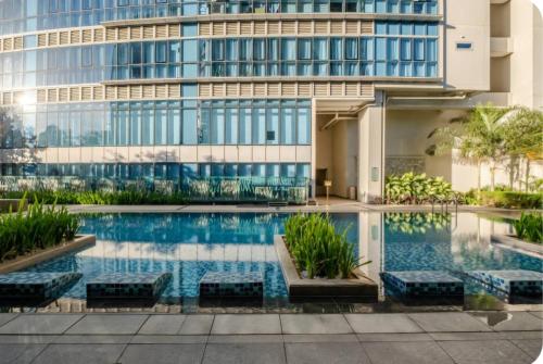 a swimming pool in front of a building at Mystay25V-ParksuitesTower1 in Manila