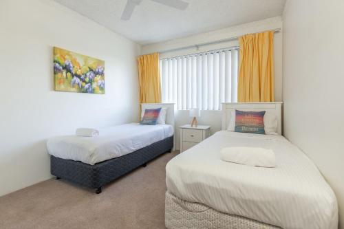 a bedroom with two beds and a window at Sandpebbles 1 Pebbly Beach in Forster