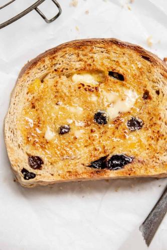 a piece of bread with blueberries on a plate at Comfort Inn Traralgon in Traralgon