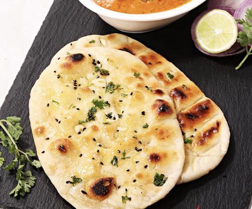 a close up of two naan pizzas on a table at Comfort Inn Traralgon in Traralgon