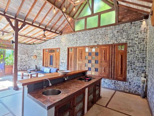 a kitchen with a sink and a counter top at Samsara Villas in Gili Air