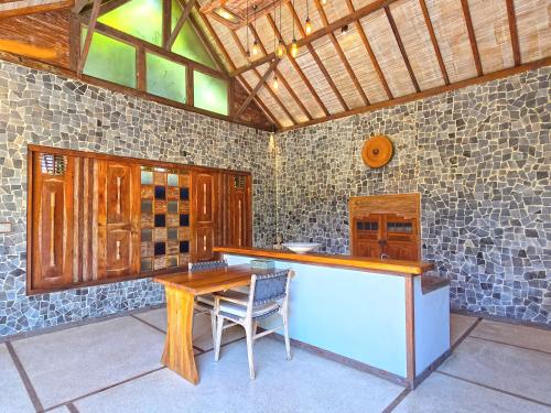 a kitchen with a table and a table and chairs at Samsara Villas in Gili Air
