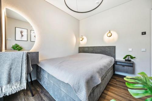 a bedroom with a bed and a mirror at Dune Suite - Palangos loftai in Palanga