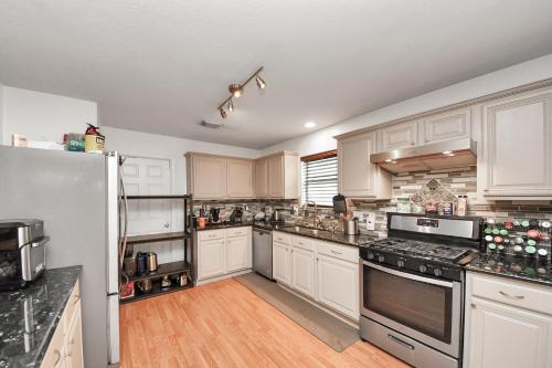 a kitchen with white cabinets and a white refrigerator at Ground Floor Suite fast WiFi&TV in Katy
