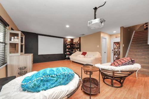 a living room with two beds and a couch at Ground Floor Suite fast WiFi&TV in Katy