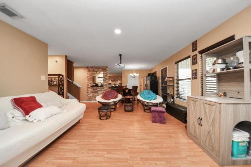 a living room with a white couch and a table at Ground Floor Suite fast WiFi&TV in Katy
