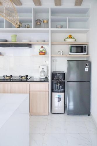 a kitchen with a stainless steel refrigerator and appliances at Dirumahjogja in Jarakan