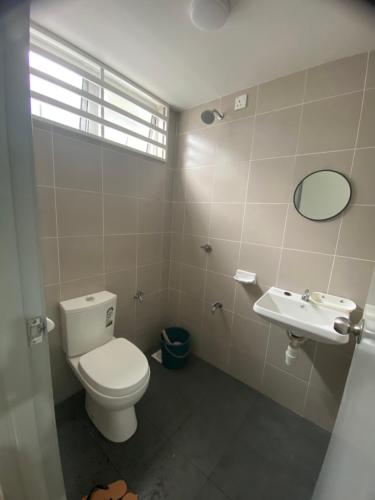 a bathroom with a toilet and a sink at Homestay DNailah in Kampong Jelatang