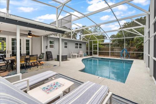 a swimming pool in a house with a glass ceiling at Palm Paradise in Cocoa Beach