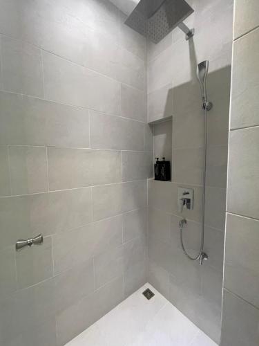 a bathroom with a shower with a shower head at HOMETELhdy in Hat Yai