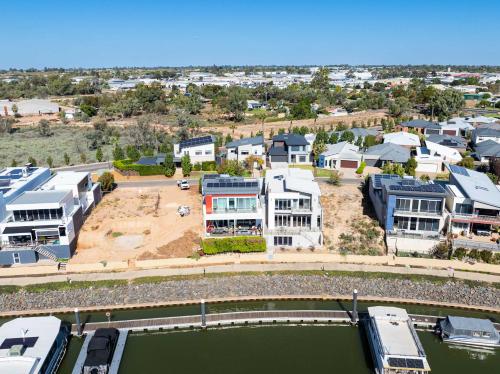an aerial view of a town with houses and a river at Riverfront Family Home in Mildura in Mildura