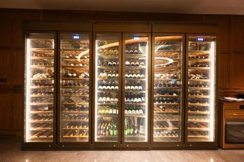 a refrigerator filled with lots of wine bottles at SAVHE Atour Hotel on the Bund Nanjing Road Pedestrian Street -Free night snacks and afternoon tea in Shanghai