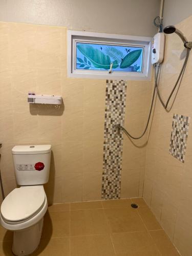 a bathroom with a toilet and a window and a shower at Ler Hostel 65 in Chaweng