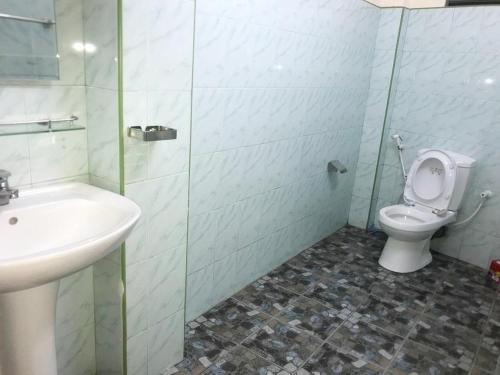 a bathroom with a sink and a toilet at UDF City Hotel in Kandy