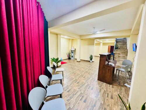 a conference room with red curtains and a desk at The Regent Hotel in Colombo