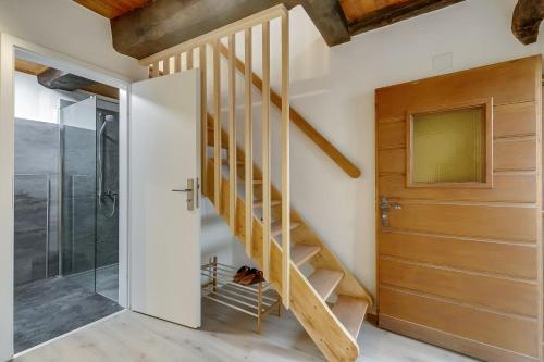 a wooden staircase in a house with a glass door at Ca dal 1785 Centovalli - Happy Rentals in Intragna