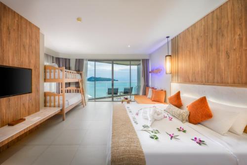 a hotel room with a bed and a television at Kalima Resort and Spa in Patong Beach
