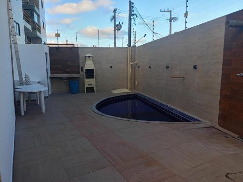 a swimming pool in the middle of a patio at Casa de Veraneio na Praia do Francês in Marechal Deodoro