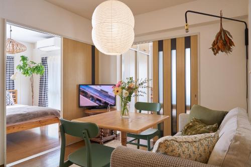 a living room with a couch and a table at Holiday Places /SHIBUYA 5min by train (Sangenjaya) in Tokyo