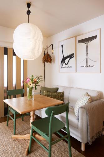 a living room with a table and a couch at Holiday Places /SHIBUYA 5min by train (Sangenjaya) in Tokyo