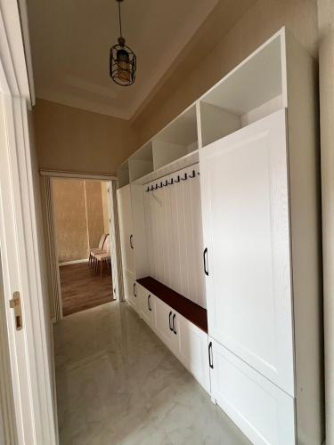 a walk in closet with white cabinets and a door at Sumqayit Kristal3 in Sumqayıt