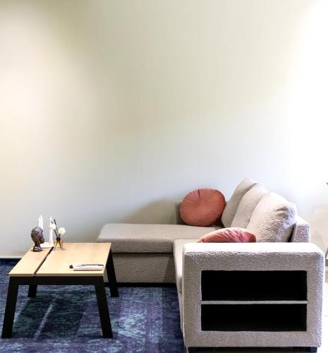 a living room with a couch and a coffee table at LĀr - the Hidden Gem in Anatolí