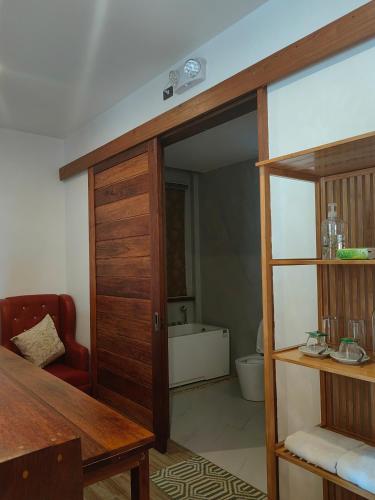 a room with a door open to a bathroom at Orange Pearl Beach Resort in El Nido