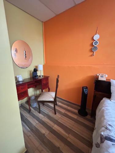 a bedroom with a desk and a bed and a desk at 1961 Los Naranjos Hostal in Los Naranjos