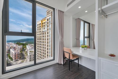 a room with a desk and large windows at La isla Apartments & Villas - Sea View & Fireworks Phu Quoc in Phu Quoc