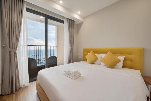 a bedroom with a bed with a view of the ocean at La isla Apartments & Villas - Sea View & Fireworks Phu Quoc in Phu Quoc