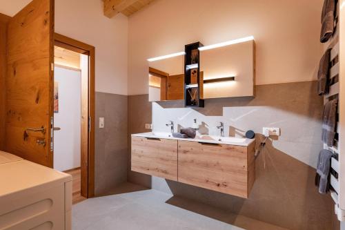 a bathroom with a sink and a mirror at Chalet Gipfelblick in Hopfgarten im Brixental