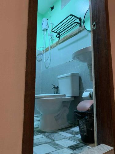 a bathroom with a toilet and a sink at Liam's Homestay El Nido in El Nido