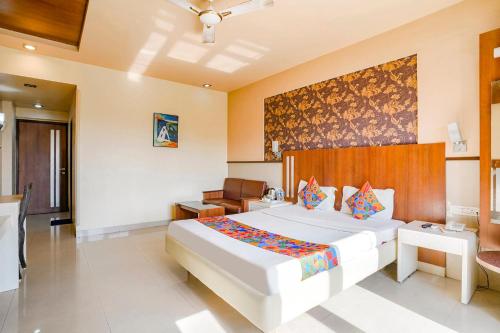 a bedroom with a large white bed in a room at FabHotel Devanshi Inn in Kalamboli