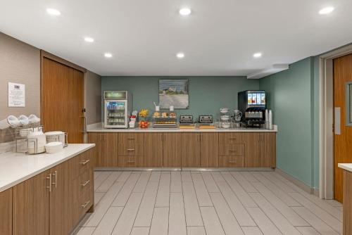 a large kitchen with wooden cabinets and a counter at Sleep Inn Oakbrook Terrace - Chicago in Oakbrook Terrace