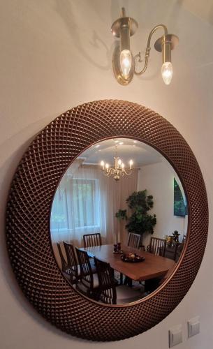 a mirror hanging on a wall in a dining room at UMANI Retreat in Buşteni