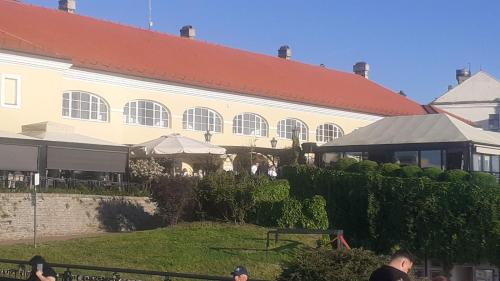 a large white building with a red roof at Apartman EXIT-TVRĐAVA in Petrovaradin