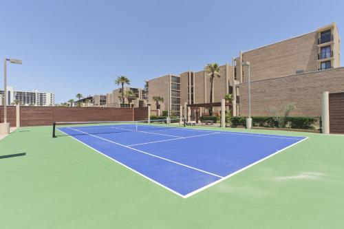 a tennis court in front of a building at Sea Vista in South Padre Island