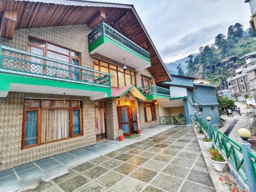 a building with two balconies on top of it at Tripti Villas in Manāli